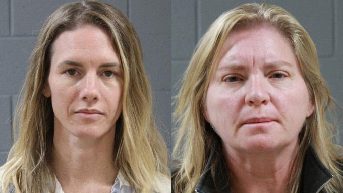 Side-by-side emotionless mug shots of Ruby Frankie and Jody Hildebrandt set up against a gray brick backdrop. 