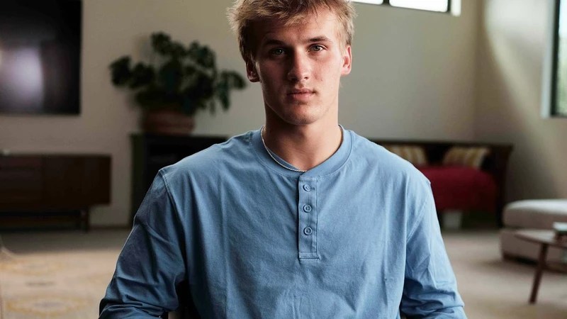 Chad Frankie, Ruby Frankie's oldest son, wearing in a blue shirt sharing his thoughts on his mother during a serious interview for 'Devil in the Family'.