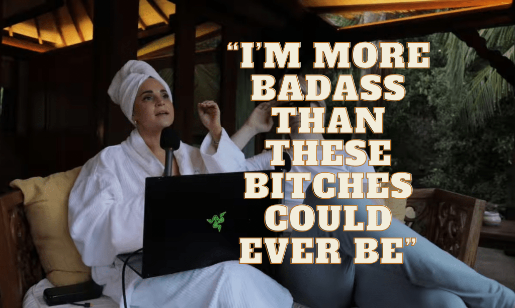Rosanna Pansino sits outside in bathrobe and towel on her head with angry look while saying "I'm more badass than these bitches could ever be". She has her black laptop on her lap and her boyfriend is sitting next to her.